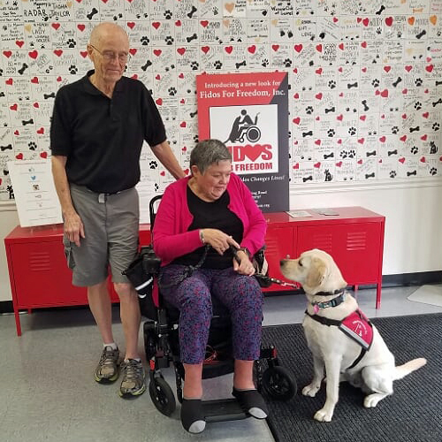 Terry and Bitsy with their service dog Maya at a Fidos for Freedom, Inc. event.
