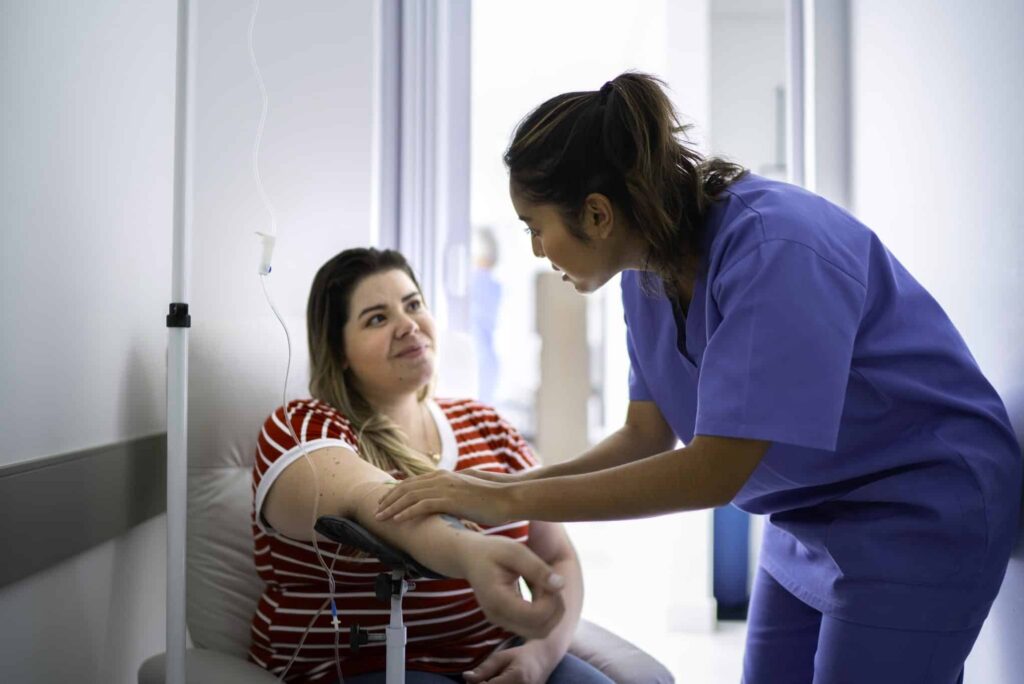 An infusion nurse giving a patient an IVIg infusion.