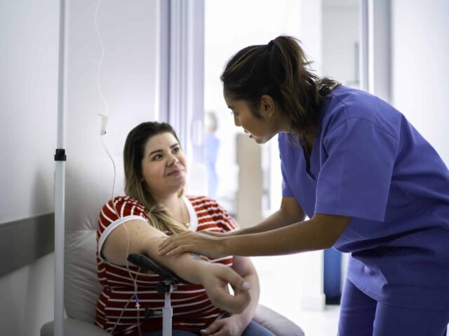 An infusion nurse giving a patient an IVIg infusion.