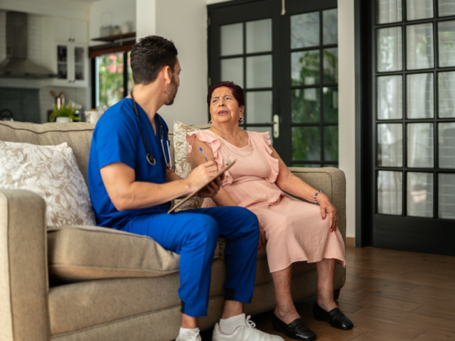 Nurse helping patient with neurological condition.