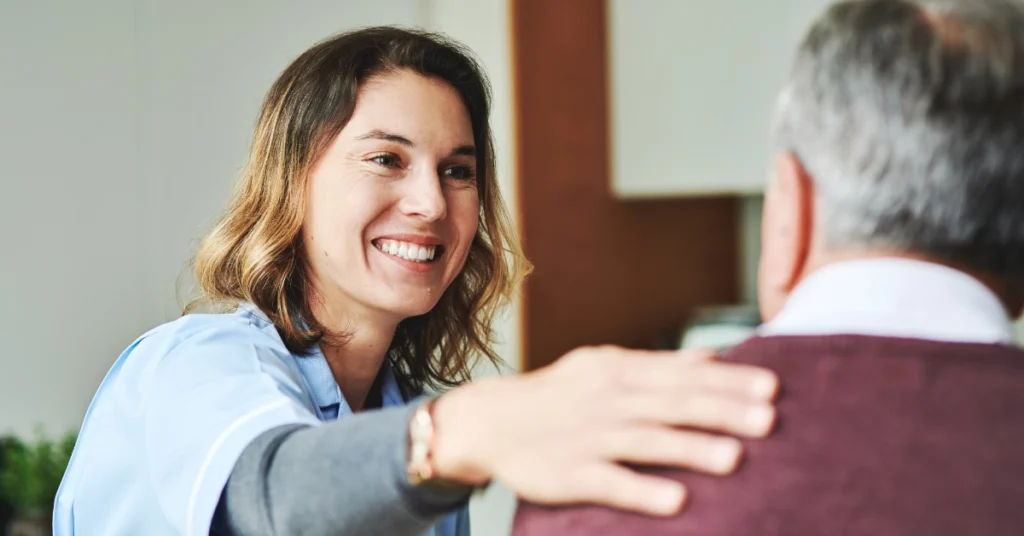 Happy female nurse checking on patient.