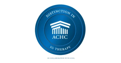 Blue Emblem Representing ACHC Distinction in Ig Therapy in Partnership with IgNS