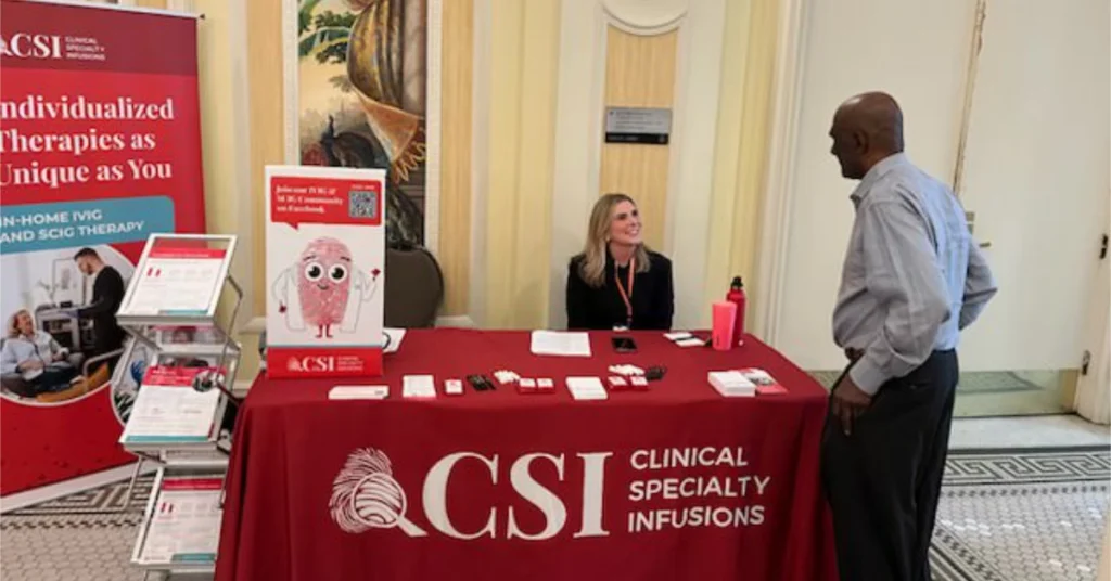 Patient advocacy team speaking with a patient at a rare disease event.