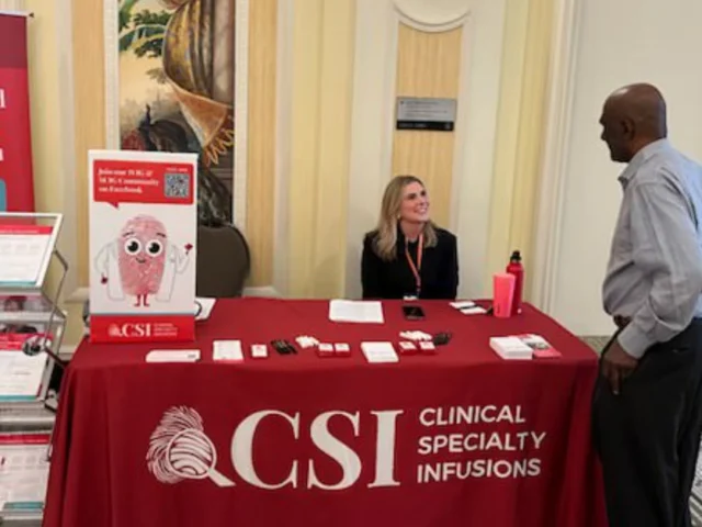 Patient advocacy team speaking with a patient at a rare disease event.