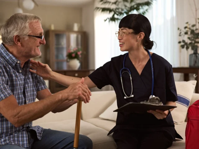 Home Infusion Nurse Visiting Elderly Man for Checkup and Support.