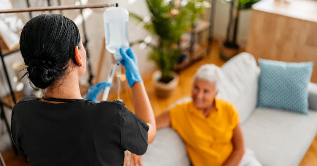 Nurse administering infusion therapy at home.
